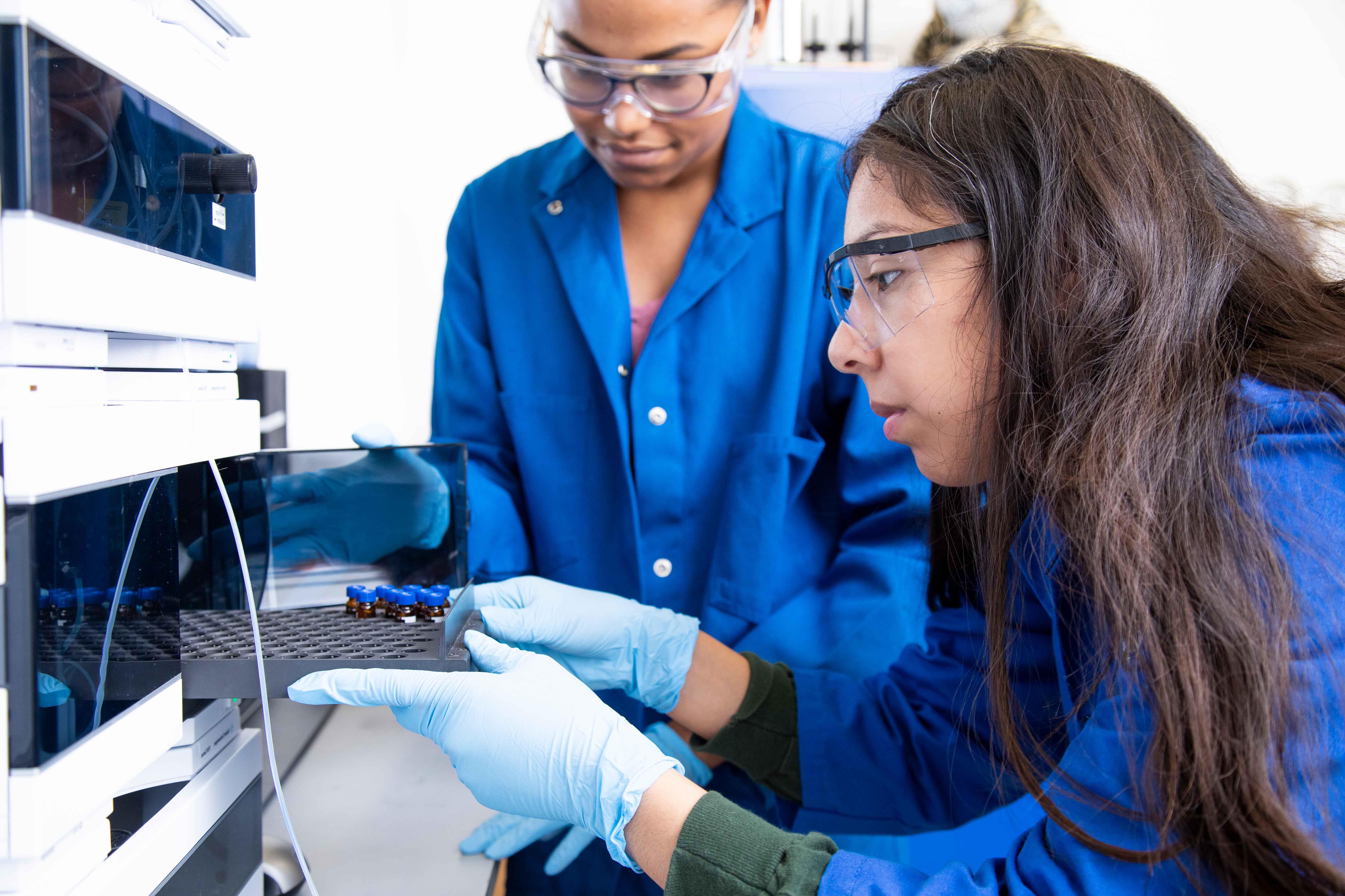 Two students working on a chemistry experiment